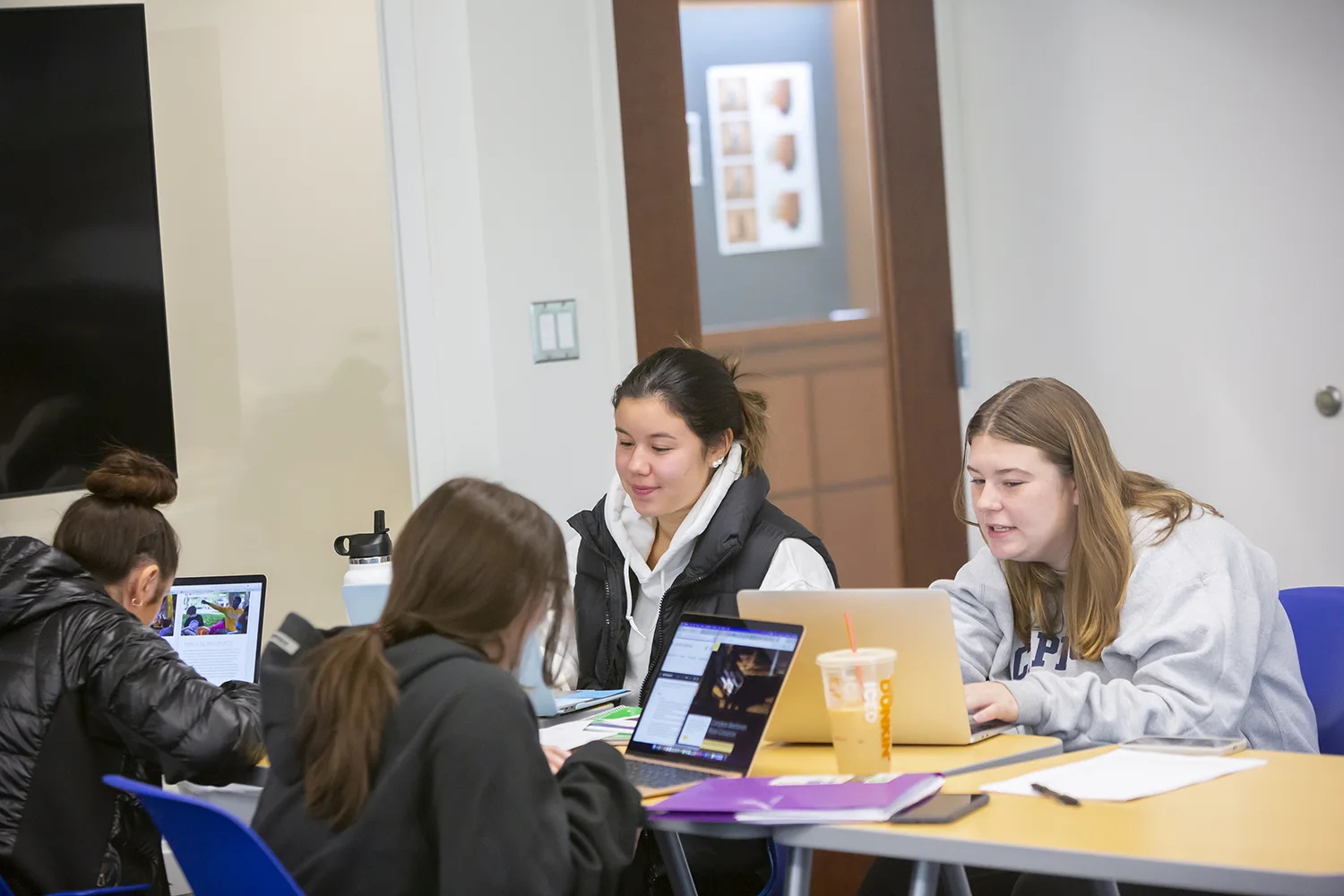 Students in a classroom working on a group project