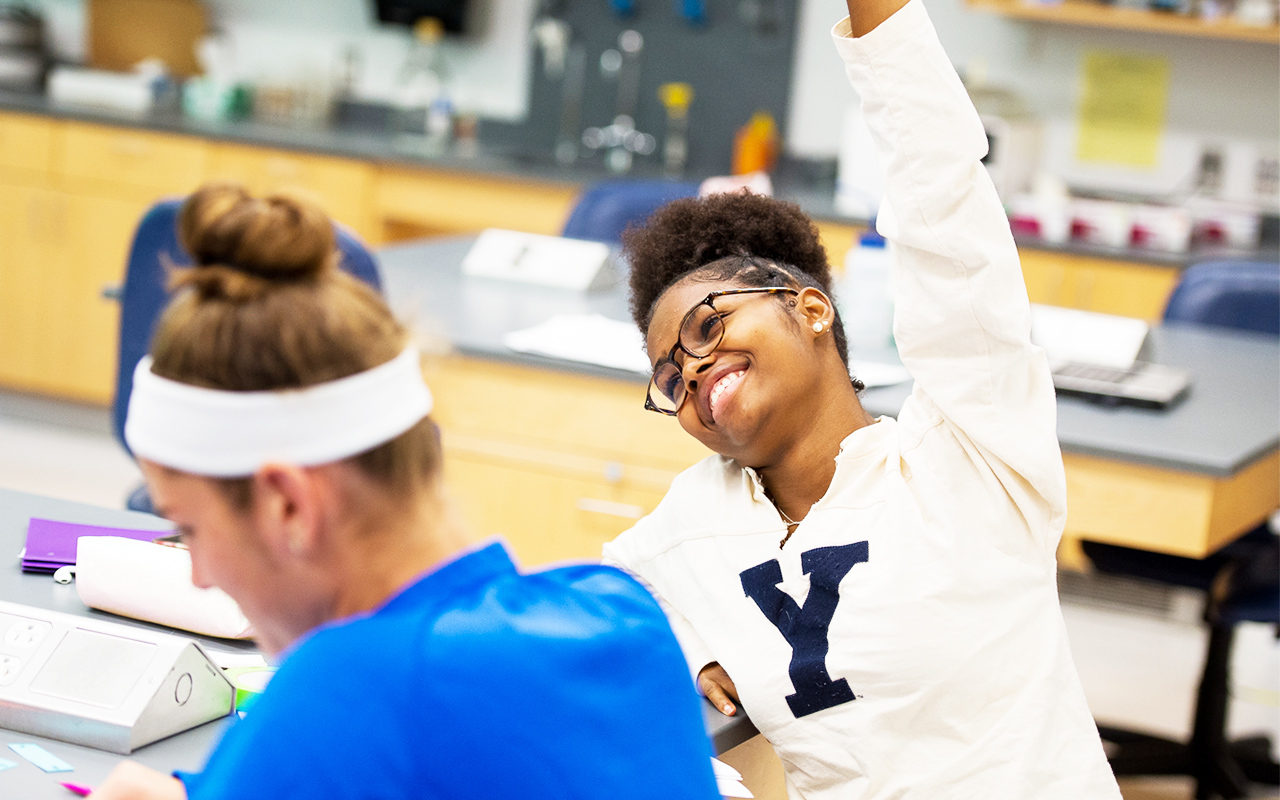 Assumption student raising her hand in class