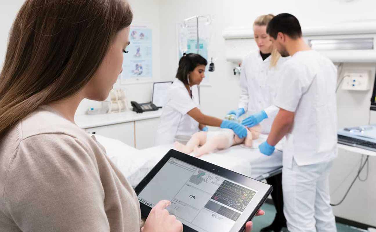 nursing students working with Apple technology