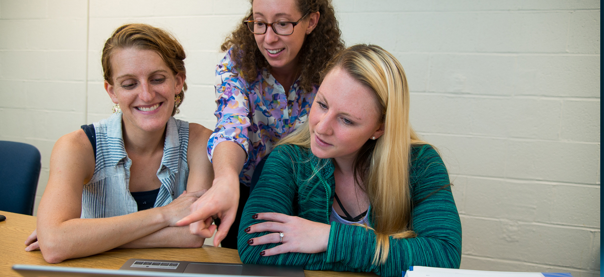 Students and a faculty member in Assumption's Special Education program review a colleagues work. Assumption's program prepares students for successful careers in teaching students with special needs in both inclusive and non-inclusive classroom environments.