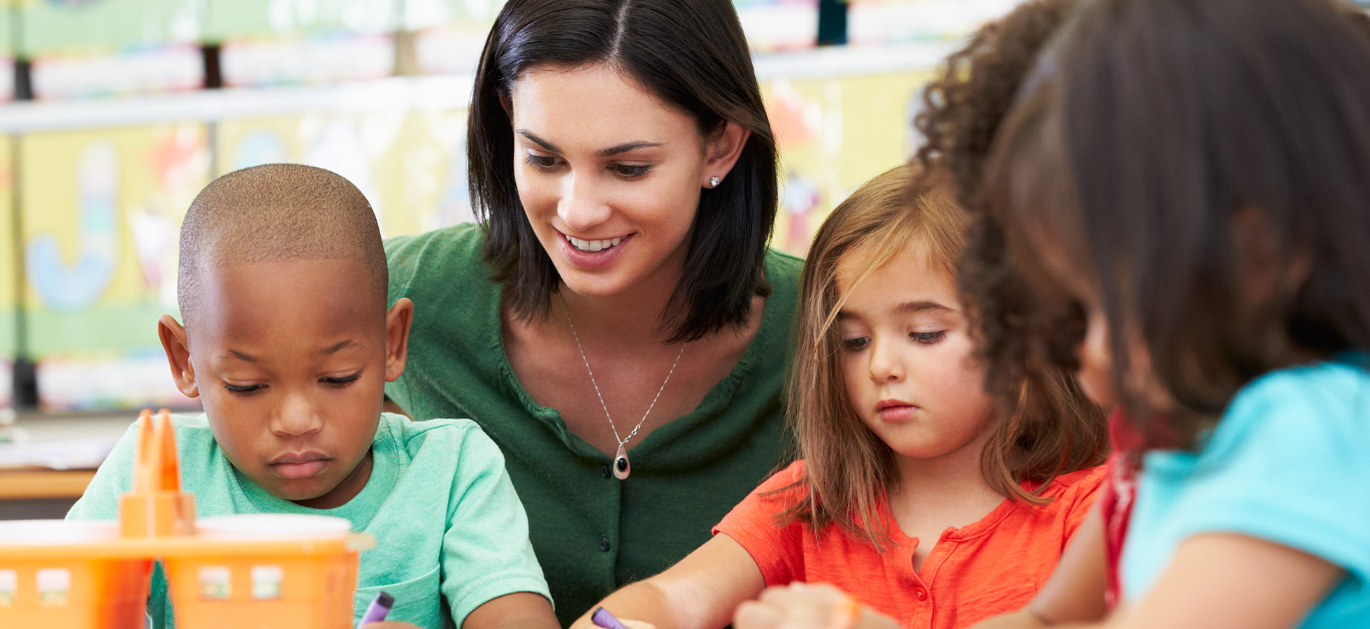 A teacher working with children in a classroom setting. Assumption University's Special Education programs prepare future classroom leaders.