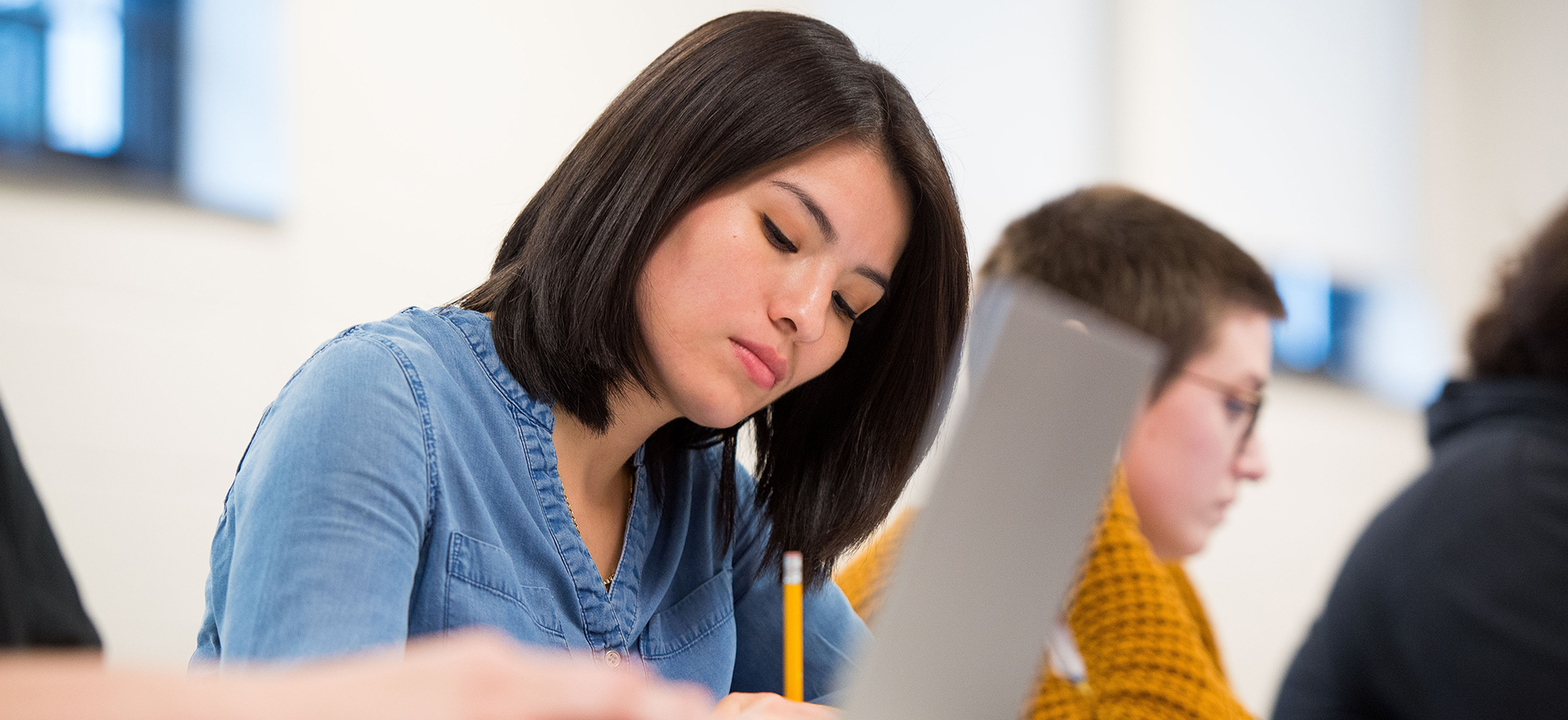 Photo of a student in a classroom used to promote Assumption University's Clinical Counseling Psychology program.