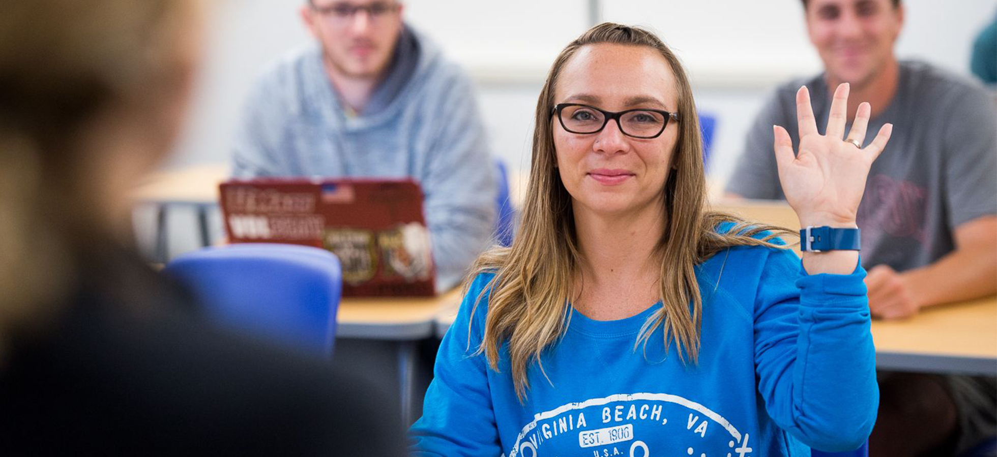 An Assumption University student in a classroom on the Worcester campus.