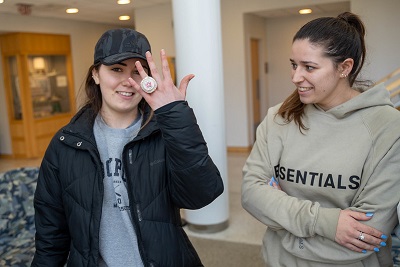 Assumption students try on for size Zach Triner's Super Bowl ring.