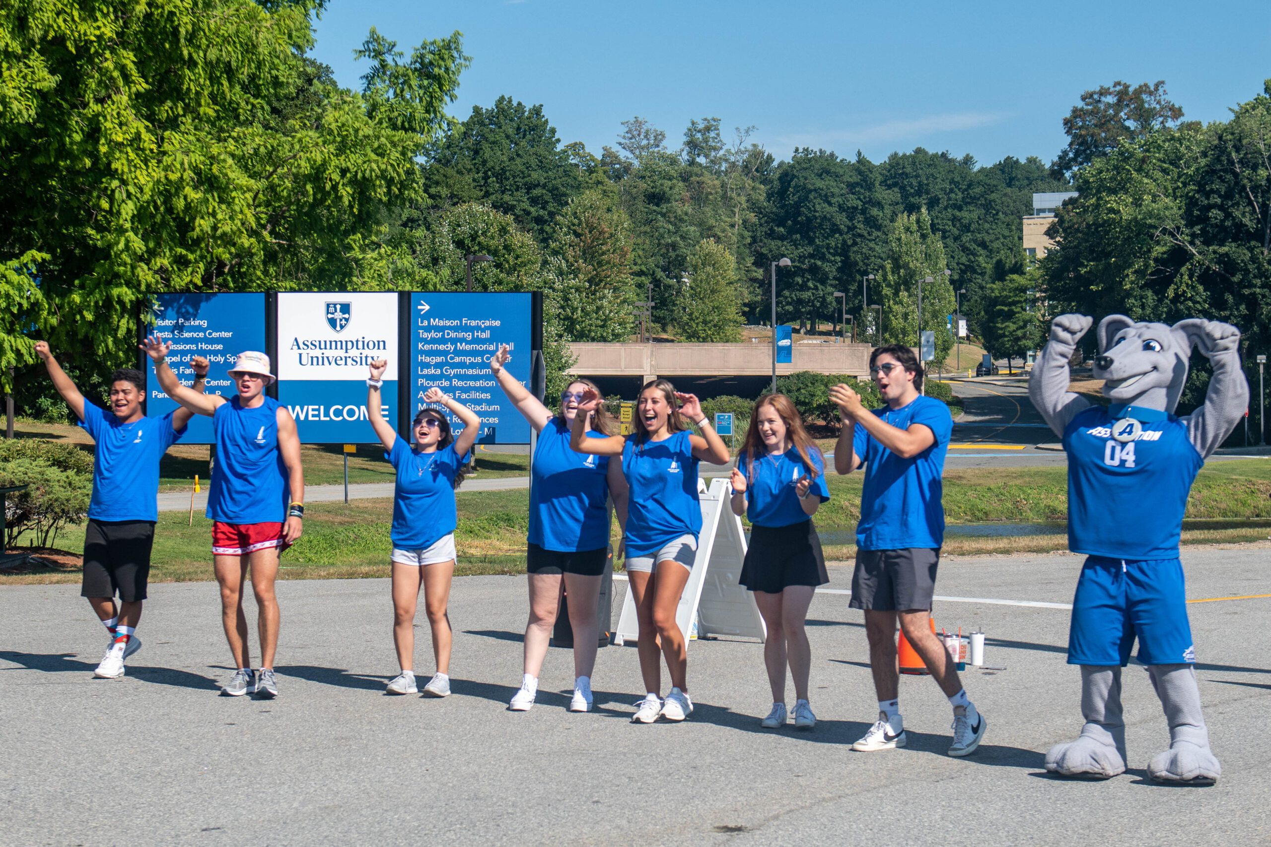 Group of Assumption students welcoming people to campus.