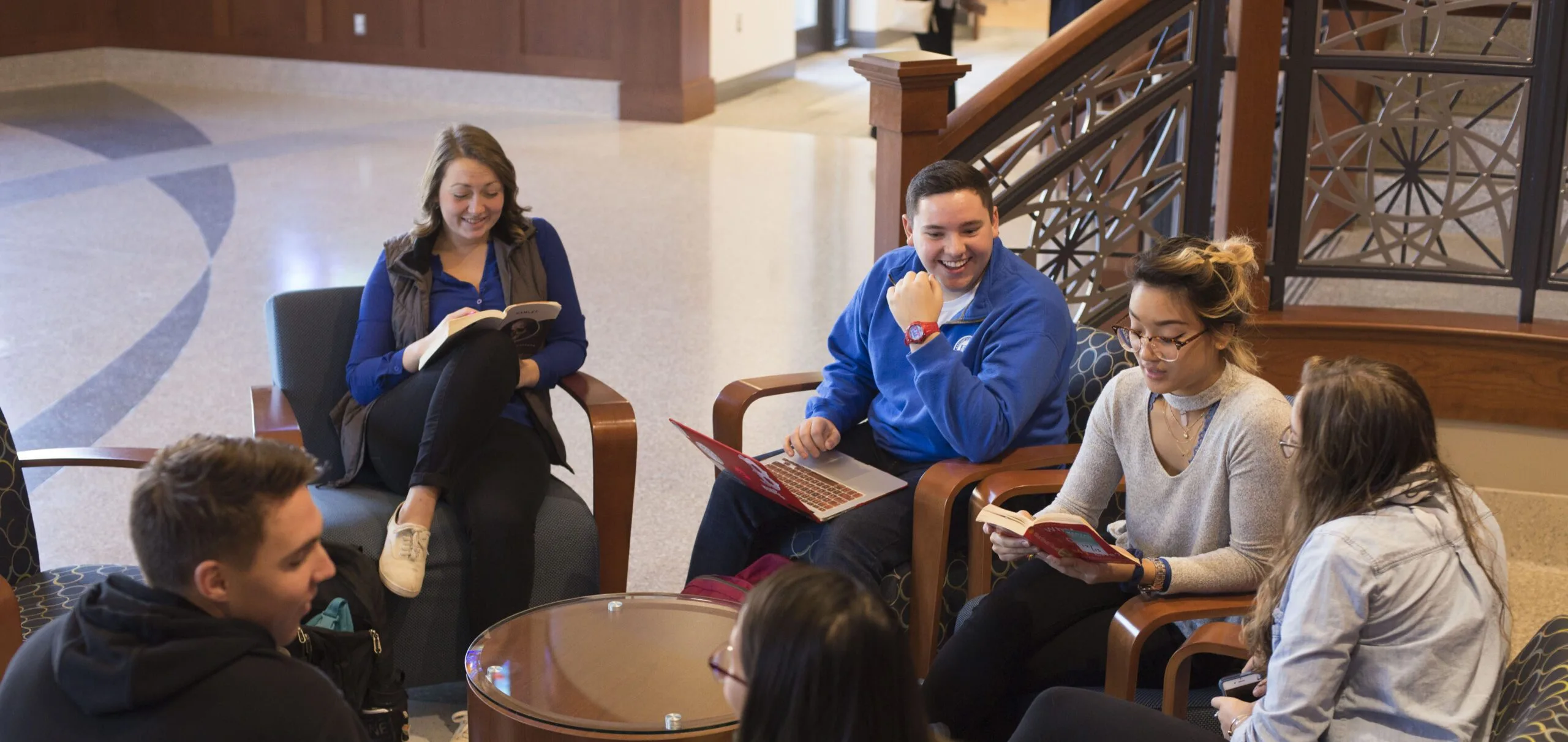 Group of students sitting around a circle table.