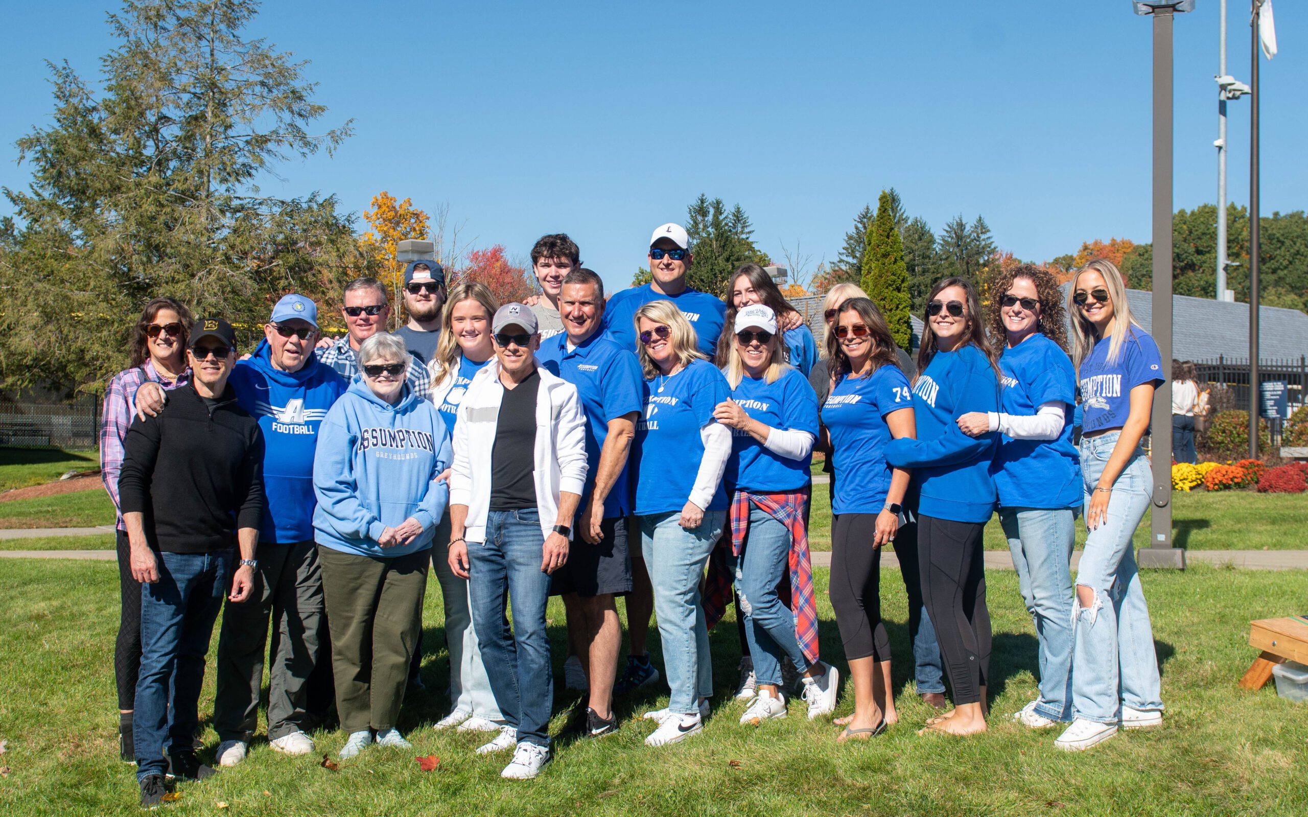 Group of alumni in Assumption blue posing for a picture.