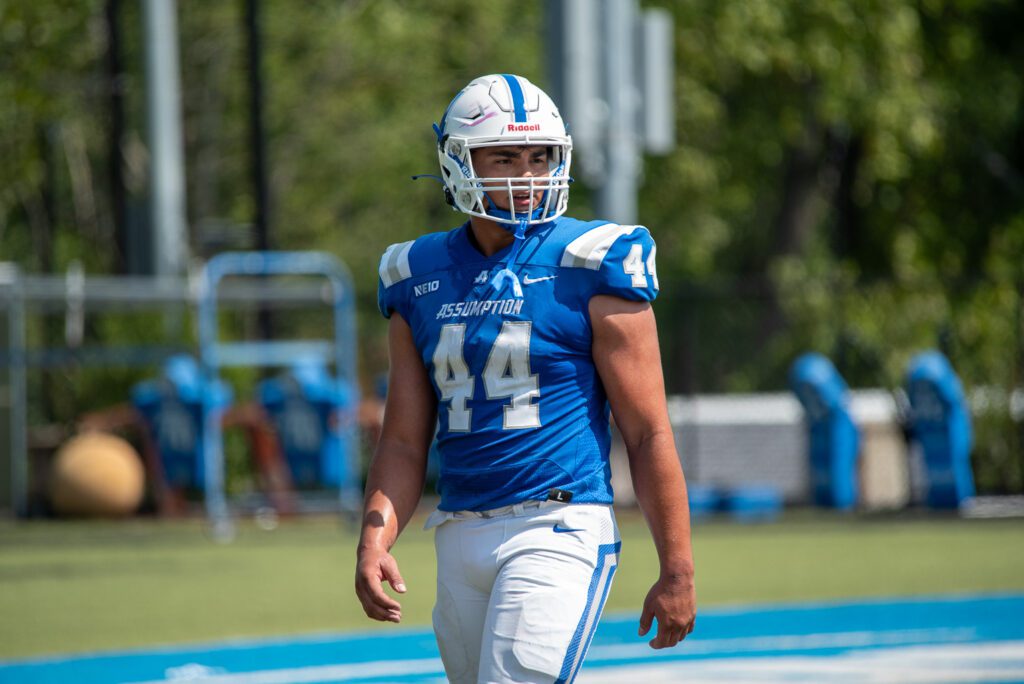 Assumption Greyhounds student athlete Lorenzo Valencia (#44) wearing a blue football uniform