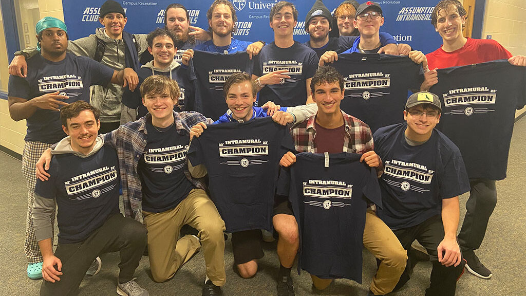 Group of Assumption students pose with their intramural champion t-shirts