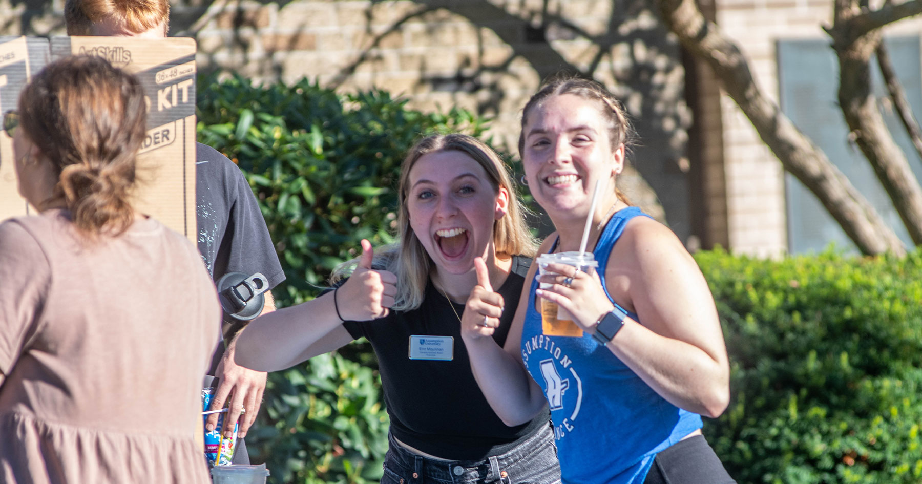 Assumption students smiling at a clubs and activities fair