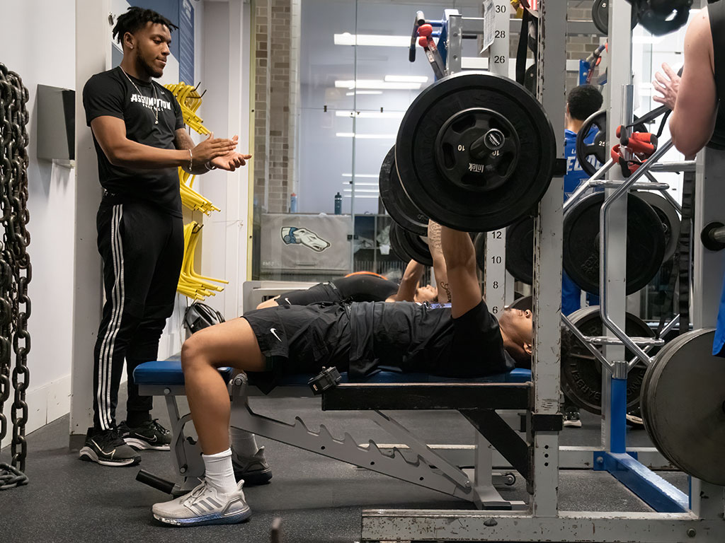 Assumption students lifting weights