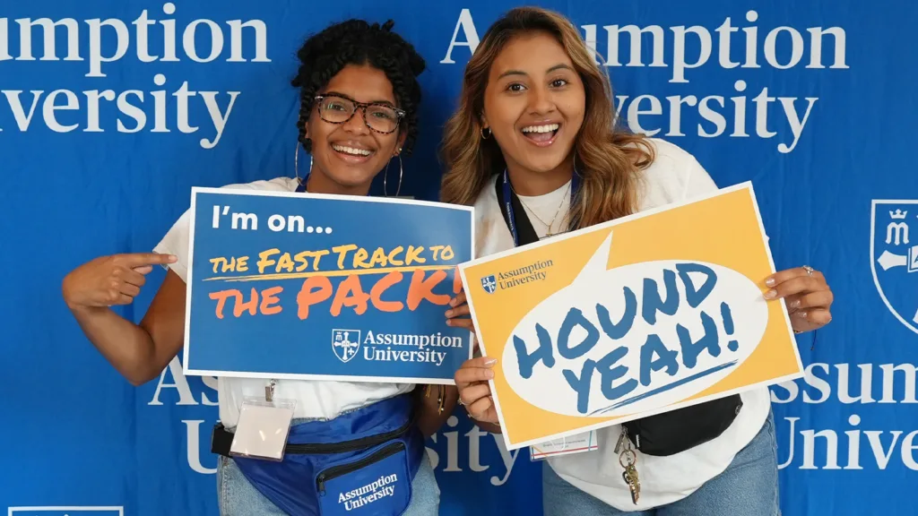 Assumption University students holding branded signs