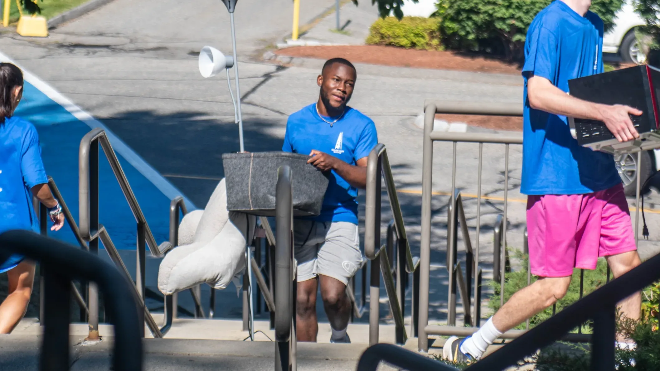 Assumption University student helps move a first-year student in to their dorm room