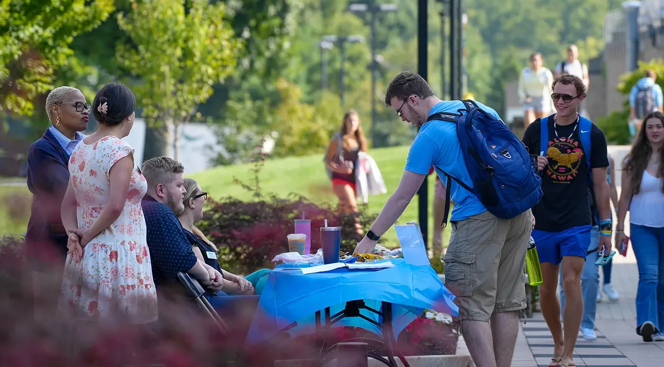 Students at a resources table on the first day of classes.