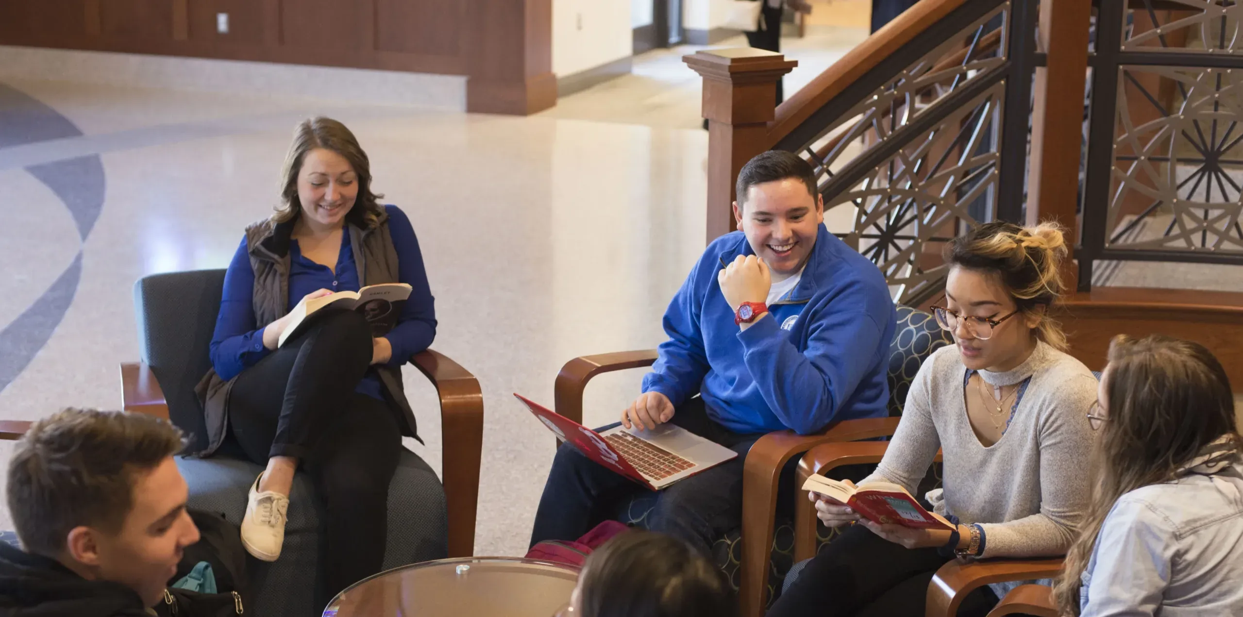 Group of students sitting around a circle table.