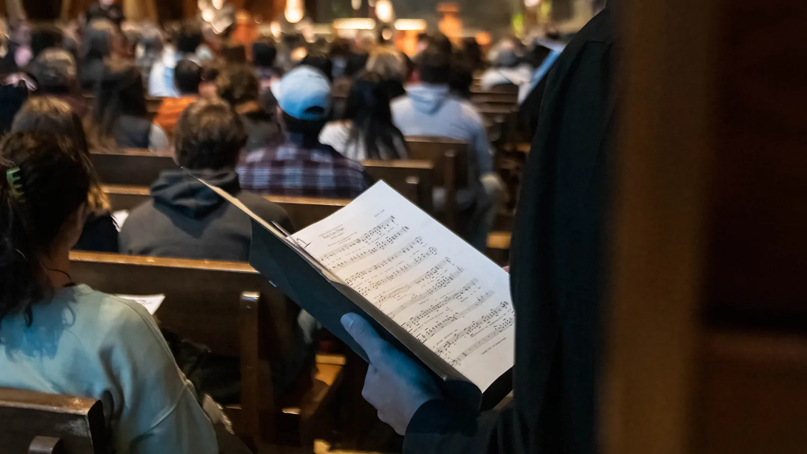 Person holding a sheet of music